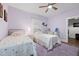 Charming bedroom featuring two beds, wood floors, purple rug, and bright natural light at 6447 Beulah Church Rd, Liberty, NC 27298