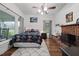 Bright bedroom features hardwood floors, a ceiling fan and a charming brick fireplace at 6447 Beulah Church Rd, Liberty, NC 27298