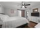 Bright bedroom featuring wood floors and a white dresser with a television at 6447 Beulah Church Rd, Liberty, NC 27298