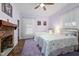 Comfortable bedroom with twin beds, brick fireplace and purple shag carpet at 6447 Beulah Church Rd, Liberty, NC 27298