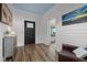 Welcoming entryway features wood-look floors, black doors, and access to porch with rocking chairs at 6447 Beulah Church Rd, Liberty, NC 27298