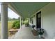 Relaxing front porch with rocking chairs and blue hydrangeas, perfect for enjoying the view at 6447 Beulah Church Rd, Liberty, NC 27298