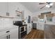 Well-lit kitchen with white cabinets, marble countertops, stainless steel appliances, and tile backsplash at 6447 Beulah Church Rd, Liberty, NC 27298