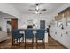 White kitchen features a ceiling fan, white cabinets, butcher block counters, and a breakfast bar with seating at 6447 Beulah Church Rd, Liberty, NC 27298