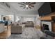 Comfortable living room with fireplace, wooden beams, a fan, and neutral-toned furniture at 6447 Beulah Church Rd, Liberty, NC 27298