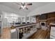 Open-concept living space features a wood accent wall, fireplace, and a breakfast bar with seating at 6447 Beulah Church Rd, Liberty, NC 27298