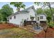 Back patio features an outdoor dining area, concrete flooring, and an outdoor privacy fence at 6447 Beulah Church Rd, Liberty, NC 27298