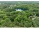 Scenic aerial view of tranquil lake surrounded by lush green trees and neighborhood at 6925 Valley Lake Dr, Raleigh, NC 27612