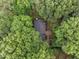 An aerial view of a charming home nestled amongst verdant trees at 6925 Valley Lake Dr, Raleigh, NC 27612