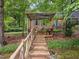 Inviting backyard featuring a rustic pergola and quaint seating area, perfect for relaxation at 6925 Valley Lake Dr, Raleigh, NC 27612