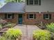 Beautiful backyard with brick patio and garden beds, featuring a serene outdoor space at 6925 Valley Lake Dr, Raleigh, NC 27612