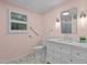 Well-lit bathroom featuring a modern vanity and a hexagon tile floor at 6925 Valley Lake Dr, Raleigh, NC 27612