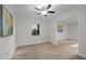 Cozy bedroom with neutral walls, carpet flooring, ceiling fan, and a bright window at 6925 Valley Lake Dr, Raleigh, NC 27612