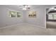 Bright bedroom featuring a ceiling fan and window overlooking lush greenery at 6925 Valley Lake Dr, Raleigh, NC 27612