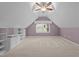 Large bonus room with built-in cabinets, plush carpeting, and natural light at 6925 Valley Lake Dr, Raleigh, NC 27612