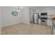 Open dining area adjacent to the kitchen with stainless steel appliances and tiled floor at 6925 Valley Lake Dr, Raleigh, NC 27612