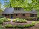 Lovely home exterior with brick facade, lush landscaping, and charming curb appeal at 6925 Valley Lake Dr, Raleigh, NC 27612