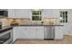 Bright kitchen featuring stainless steel appliances and white cabinetry at 6925 Valley Lake Dr, Raleigh, NC 27612