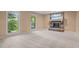 Spacious living room featuring a classic brick fireplace and large windows at 6925 Valley Lake Dr, Raleigh, NC 27612