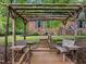 Backyard featuring a wooden pergola with built-in benches and serene outdoor space at 6925 Valley Lake Dr, Raleigh, NC 27612