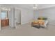 Bright primary bedroom with ensuite bathroom, a ceiling fan, plush carpet, and ample natural light at 711 Keystone Park Dr # 7, Morrisville, NC 27560