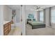 Bright bedroom with ensuite bathroom featuring a ceiling fan, plush carpet, and large windows for ample natural light at 711 Keystone Park Dr # 7, Morrisville, NC 27560