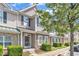 Attractive townhome showcasing stone and siding accents with lush greenery at 711 Keystone Park Dr # 7, Morrisville, NC 27560