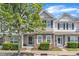 Charming townhome with stone accents, manicured bushes, and a tree-lined street at 711 Keystone Park Dr # 7, Morrisville, NC 27560