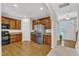 Open kitchen featuring wooden cabinets, stainless steel refrigerator, and access to the foyer at 711 Keystone Park Dr # 7, Morrisville, NC 27560