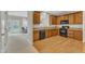 Well-equipped kitchen featuring wooden cabinets, black appliances, and hardwood floors at 711 Keystone Park Dr # 7, Morrisville, NC 27560