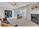 Bright living room with fireplace, bookshelves, plush carpet, ceiling fan and natural light from the sliding door and window at 711 Keystone Park Dr # 7, Morrisville, NC 27560