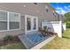 Cozy patio with a blue patterned rug, small table with chairs, and access to the backyard at 711 Keystone Park Dr # 7, Morrisville, NC 27560