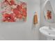 This powder room features a modern vanity, round mirror, fresh paint, and a vibrant floral print that adds a touch of elegance at 711 Keystone Park Dr # 7, Morrisville, NC 27560