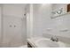 Bright, clean bathroom featuring a shower, sink, and white tile at 713 Marlboro Pl, Rocky Mount, NC 27801