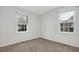 Clean bedroom featuring fresh paint, carpet, and windows at 713 Marlboro Pl, Rocky Mount, NC 27801