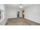 Bright living room featuring fresh paint, carpet, and ample natural light at 713 Marlboro Pl, Rocky Mount, NC 27801