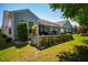 Landscaped backyard featuring a stone retaining wall and plenty of green space at 740 Blackfriars Loop, Cary, NC 27519