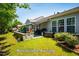 Beautiful backyard with a retractable awning, stone retaining wall and lush green lawn at 740 Blackfriars Loop, Cary, NC 27519