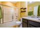 Bathroom featuring shower and granite vanity with decorative accents and storage at 740 Blackfriars Loop, Cary, NC 27519