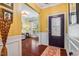Home entry with hardwood floors, decorative wainscoting, elegant lighting, and a decorative front door at 740 Blackfriars Loop, Cary, NC 27519