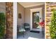 Inviting front porch featuring a seating area with decorative accents and a glass front door at 740 Blackfriars Loop, Cary, NC 27519
