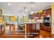 Gourmet kitchen with a large island, granite countertops, stainless steel appliances, and custom cabinetry at 740 Blackfriars Loop, Cary, NC 27519