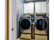 Laundry room featuring modern washer and dryer with storage cabinets at 740 Blackfriars Loop, Cary, NC 27519