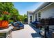 Outdoor patio with comfortable seating, grill, and beautifully landscaped surroundings at 740 Blackfriars Loop, Cary, NC 27519