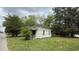 Side view of a one-story house featuring a worn exterior and small windows, surrounded by greenery at 752 Nashville Rd, Rocky Mount, NC 27803