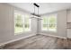 Open dining area with modern light fixture and multiple windows at 852 Cokesbury Park Lane Ln, Fuquay Varina, NC 27526