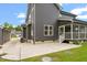 Back exterior view showcasing the outdoor patio, screened porch, and stone accents at 852 Cokesbury Park Lane Ln, Fuquay Varina, NC 27526