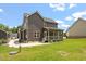 Exterior backyard with a view of the screened in porch and stone accents at 852 Cokesbury Park Lane Ln, Fuquay Varina, NC 27526