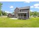 Exterior backyard featuring the screened in porch and a well-maintained lawn at 852 Cokesbury Park Lane Ln, Fuquay Varina, NC 27526