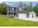 Charming two-story home with a well-manicured lawn, two car garage, and inviting front porch with white picket fence at 852 Cokesbury Park Lane Ln, Fuquay Varina, NC 27526